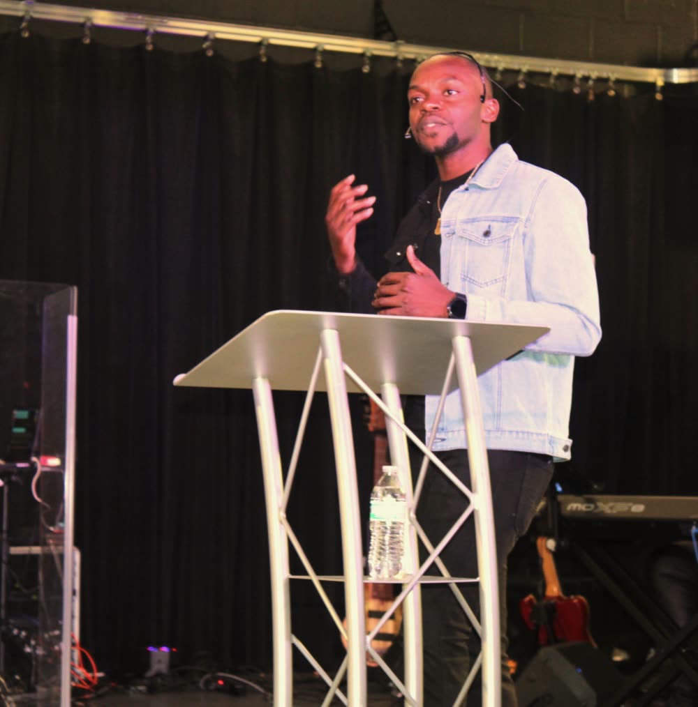 Mac Jean-Pierre preaching at a pulpit